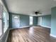 Spacious living room featuring laminate floors, fresh blue paint, and newer windows and trim at 601 Duane St, Franklin, IN 46131