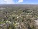 Aerial view showcasing the neighborhood, surrounded by lush greenery and mature trees at 6025 Crows Nest Dr, Indianapolis, IN 46228