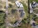 Aerial view of a home with a large backyard surrounded by mature trees and other residential properties at 6025 Crows Nest Dr, Indianapolis, IN 46228