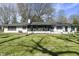 Rear view of the home featuring a well-maintained backyard and a peaceful setting at 6025 Crows Nest Dr, Indianapolis, IN 46228