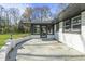 Back patio of home with spacious area and screen-in porch, perfect for outdoor entertaining at 6025 Crows Nest Dr, Indianapolis, IN 46228