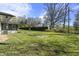 Lush backyard with a mix of green lawn, mature trees, and perimeter hedges for privacy at 6025 Crows Nest Dr, Indianapolis, IN 46228