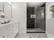 Bathroom featuring dual shower heads and glass doors in a tiled shower, with an elegant double vanity at 6025 Crows Nest Dr, Indianapolis, IN 46228