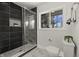 Modern bathroom features sleek black tile, a glass-enclosed shower, and a window with a pleasant view at 6025 Crows Nest Dr, Indianapolis, IN 46228