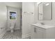 Modern bathroom with mosaic tile floor, white vanity, and a window, offering a fresh, clean aesthetic at 6025 Crows Nest Dr, Indianapolis, IN 46228