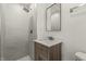 Bathroom featuring a tiled shower, modern vanity with marble countertop, and updated fixtures for a spa-like feel at 6025 Crows Nest Dr, Indianapolis, IN 46228