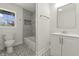 Stylish bathroom featuring modern fixtures, mosaic tile floor, a bathtub with gray tiling and a window at 6025 Crows Nest Dr, Indianapolis, IN 46228