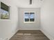Bright bedroom with natural light from two windows, featuring neutral walls and wood-look flooring at 6025 Crows Nest Dr, Indianapolis, IN 46228