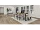 Comfortable dining area with light colored walls, hardwood floors, a modern rug, and stylish decor at 6025 Crows Nest Dr, Indianapolis, IN 46228
