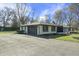 Side view showcasing the home's attached garage and well-maintained landscaping at 6025 Crows Nest Dr, Indianapolis, IN 46228