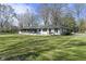 Exterior shot displaying the well-kept lawn and screened in porch, great for outdoor living at 6025 Crows Nest Dr, Indianapolis, IN 46228