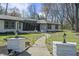 A well-lit pathway leads to this stylish home with a beautifully landscaped yard and mature trees at 6025 Crows Nest Dr, Indianapolis, IN 46228