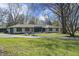 Classic ranch home with a long, paved driveway, complemented by a lush, green lawn at 6025 Crows Nest Dr, Indianapolis, IN 46228