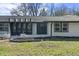 Beautiful white brick home with a dark front door, modern lighting, and a professionally landscaped front yard at 6025 Crows Nest Dr, Indianapolis, IN 46228