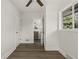 Hallway leading to a bathroom, featuring wood-look flooring and neutral wall color to offer a clean transition at 6025 Crows Nest Dr, Indianapolis, IN 46228