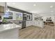 Modern kitchen with stainless steel appliances, white cabinets, herringbone tile backsplash and open-concept layout at 6025 Crows Nest Dr, Indianapolis, IN 46228