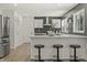 Stylish kitchen with white cabinets, modern backsplash, breakfast bar, and stainless steel appliances at 6025 Crows Nest Dr, Indianapolis, IN 46228