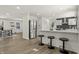Modern kitchen with stainless steel appliances, quartz counters, and a breakfast bar with wood stools at 6025 Crows Nest Dr, Indianapolis, IN 46228