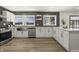 Bright kitchen featuring stainless steel appliances, white cabinets and modern finishes with abundant natural light from large windows at 6025 Crows Nest Dr, Indianapolis, IN 46228