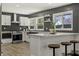 Beautiful kitchen featuring modern appliances, herringbone tile backsplash, and an eat-in bar with seating at 6025 Crows Nest Dr, Indianapolis, IN 46228