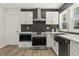 Modern kitchen design with stainless steel appliances, white cabinets and herringbone tile backsplash providing ample storage and prep space at 6025 Crows Nest Dr, Indianapolis, IN 46228
