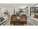 Open-concept living room, modern style, with views into kitchen, bar stool seating and natural light at 6025 Crows Nest Dr, Indianapolis, IN 46228