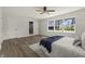 Large and sunny main bedroom featuring a ceiling fan, hardwood floors, and natural light from several windows at 6025 Crows Nest Dr, Indianapolis, IN 46228