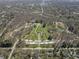 Aerial view showcases a park with winding paths, decorative plantings, and expansive green spaces at 6025 Crows Nest Dr, Indianapolis, IN 46228