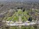Expansive aerial view of a park with winding paths, decorative trees, and manicured green spaces at 6025 Crows Nest Dr, Indianapolis, IN 46228