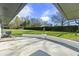 View of the spacious patio and the beautiful, expansive lawn with a manicured hedge running along the property line at 6025 Crows Nest Dr, Indianapolis, IN 46228