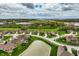 Aerial perspective showcasing the property's setting within a well-planned community, adjacent to a serene pond and green spaces at 6049 Royal Gate Pl, Indianapolis, IN 46237