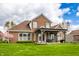 Brick house with a covered patio extending to a wide backyard, perfect for outdoor entertaining at 6049 Royal Gate Pl, Indianapolis, IN 46237