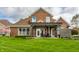 Brick house with a covered patio that opens to a well-manicured lawn at 6049 Royal Gate Pl, Indianapolis, IN 46237