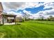 Spacious green backyard and a covered patio, perfect for outdoor living at 6049 Royal Gate Pl, Indianapolis, IN 46237