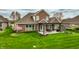 Charming backyard with a pergola, outdoor seating, and a well-maintained lawn, perfect for relaxation and entertaining at 6049 Royal Gate Pl, Indianapolis, IN 46237