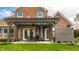 A covered backyard patio attached to a brick house overlooking a well-maintained green lawn at 6049 Royal Gate Pl, Indianapolis, IN 46237
