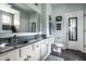 Bright bathroom featuring double sinks, a large mirror, and modern fixtures and decor at 6049 Royal Gate Pl, Indianapolis, IN 46237
