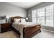 Cozy bedroom with a large window providing natural light and neutral colors at 6049 Royal Gate Pl, Indianapolis, IN 46237