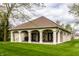 Exterior of the clubhouse featuring a covered patio with stylish columns and views of the surrounding well-maintained lawn at 6049 Royal Gate Pl, Indianapolis, IN 46237
