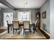 Elegant dining room with a table set for six, chandelier, and bright natural light at 6049 Royal Gate Pl, Indianapolis, IN 46237