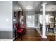 Welcoming foyer with a dark wood floor, staircase, and view into the dining area at 6049 Royal Gate Pl, Indianapolis, IN 46237