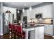 Kitchen with white cabinets, stainless appliances, granite countertops, and island with seating at 6049 Royal Gate Pl, Indianapolis, IN 46237