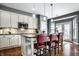 Kitchen featuring white cabinets, stainless appliances, granite countertops, and seating at 6049 Royal Gate Pl, Indianapolis, IN 46237