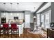 Eat-in kitchen with white cabinets, pendant lights, stainless appliances and granite countertops at 6049 Royal Gate Pl, Indianapolis, IN 46237