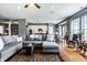 Open concept living room featuring hardwood floors, gray sofa and eat-in kitchen at 6049 Royal Gate Pl, Indianapolis, IN 46237