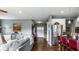 Open-concept living room flowing into a kitchen, with a comfortable gray sofa and modern decor at 6049 Royal Gate Pl, Indianapolis, IN 46237