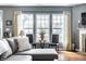 Bright living room with natural light, comfortable sofa, and accent chairs at 6049 Royal Gate Pl, Indianapolis, IN 46237
