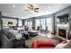 Open concept living room with hardwood floors, fireplace, and gray sectional sofa at 6049 Royal Gate Pl, Indianapolis, IN 46237
