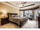 Spacious main bedroom with tray ceilings, windows, carpet, and ample natural light at 6049 Royal Gate Pl, Indianapolis, IN 46237