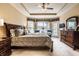 Spacious main bedroom featuring neutral tones, tray ceiling, and access to a private outdoor patio at 6049 Royal Gate Pl, Indianapolis, IN 46237
